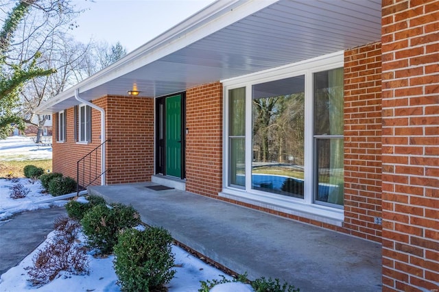 view of snow covered property entrance