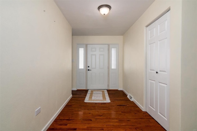 entryway with dark hardwood / wood-style flooring