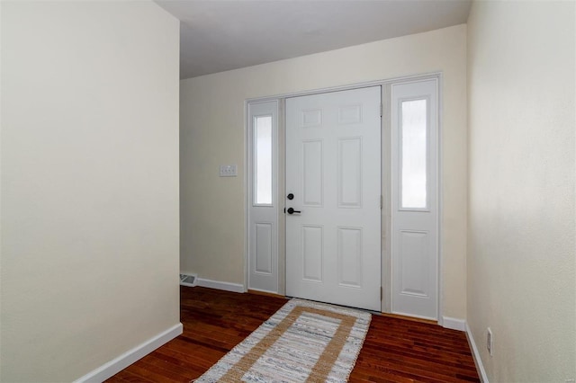 foyer entrance with dark hardwood / wood-style flooring and plenty of natural light