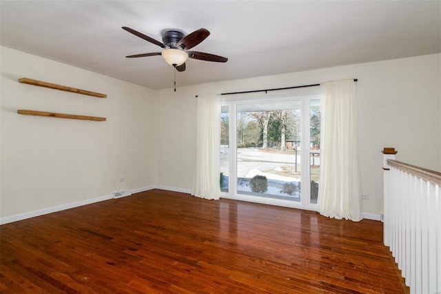 empty room featuring dark hardwood / wood-style flooring and ceiling fan