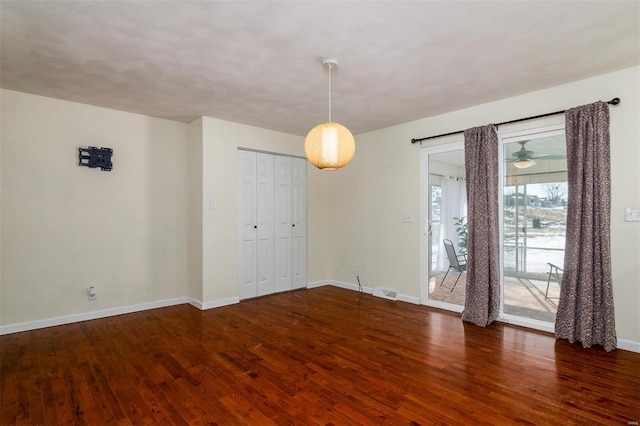 empty room featuring dark hardwood / wood-style flooring