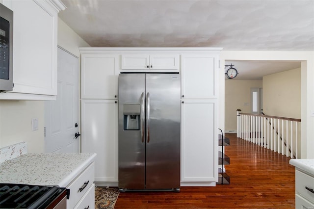 kitchen featuring light stone counters, dark wood-type flooring, white cabinets, and stainless steel refrigerator with ice dispenser