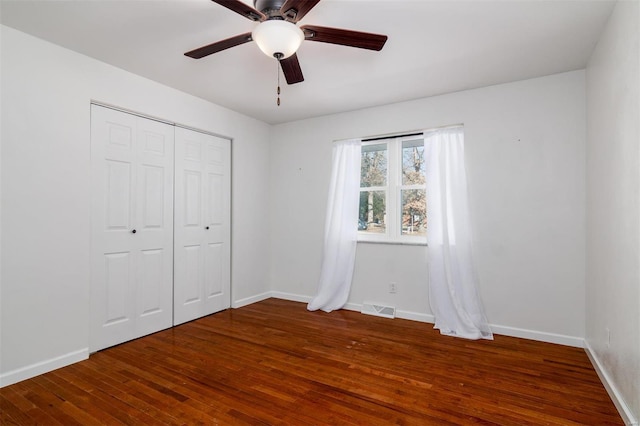 unfurnished bedroom with hardwood / wood-style floors, ceiling fan, and a closet