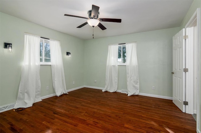 unfurnished bedroom with multiple windows, dark wood-type flooring, and ceiling fan