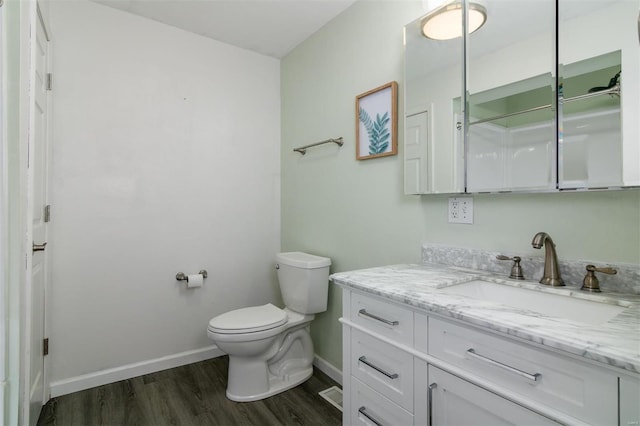 bathroom with vanity, hardwood / wood-style floors, and toilet