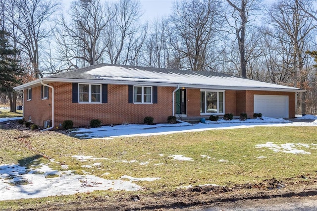 ranch-style home with a garage and a front lawn