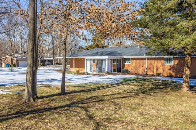 back of property featuring a yard and central AC unit