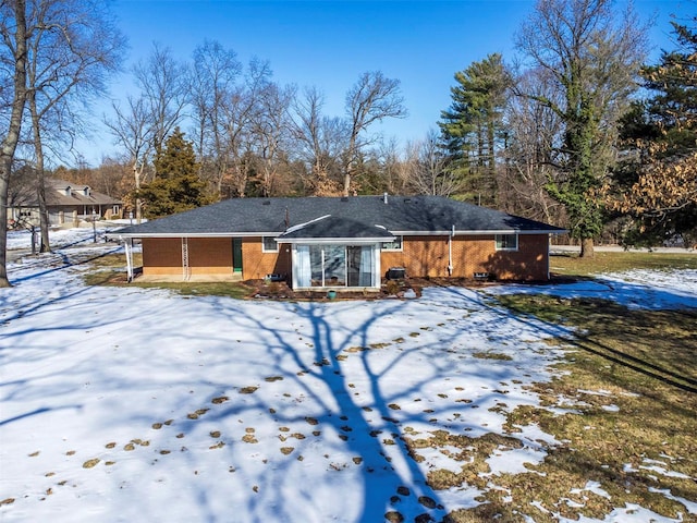 view of snow covered back of property