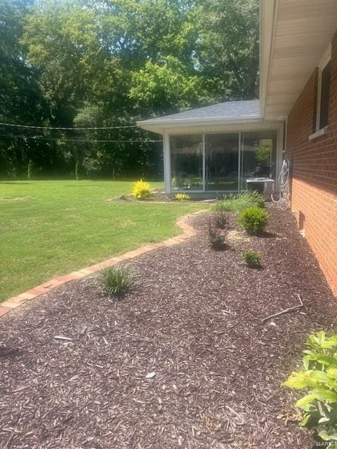 view of yard featuring a sunroom