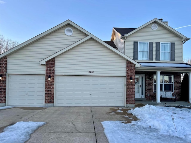 view of property featuring a garage and covered porch