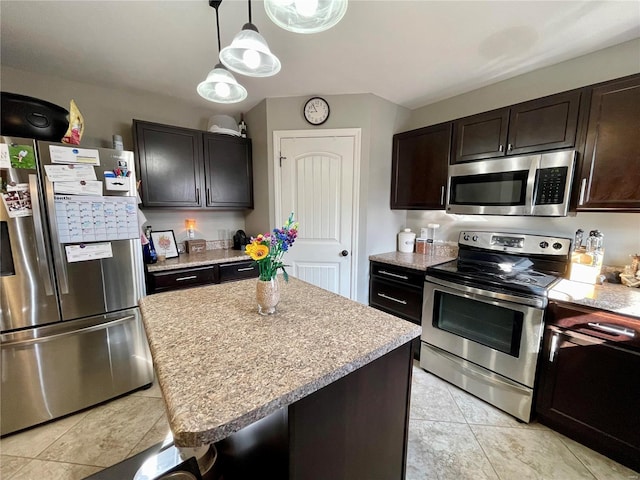 kitchen featuring dark brown cabinetry, stainless steel appliances, and a center island