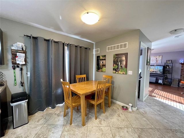 dining area with light tile patterned flooring