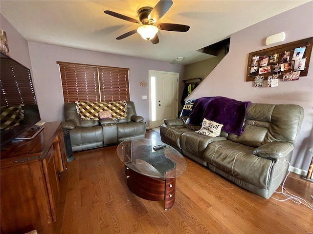 living room featuring hardwood / wood-style floors and ceiling fan