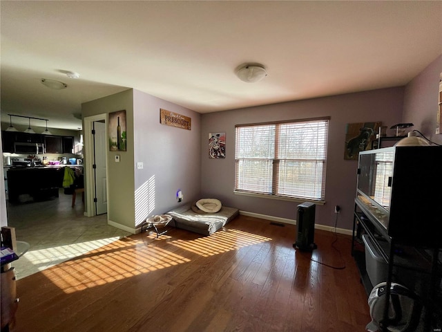 living area with hardwood / wood-style floors