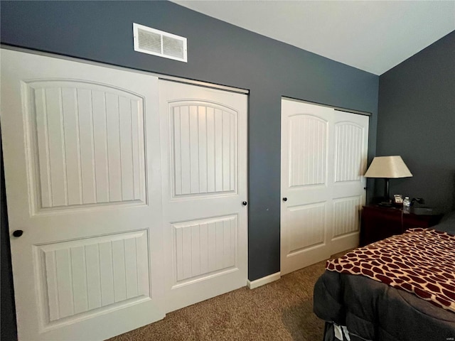 bedroom featuring lofted ceiling and carpet