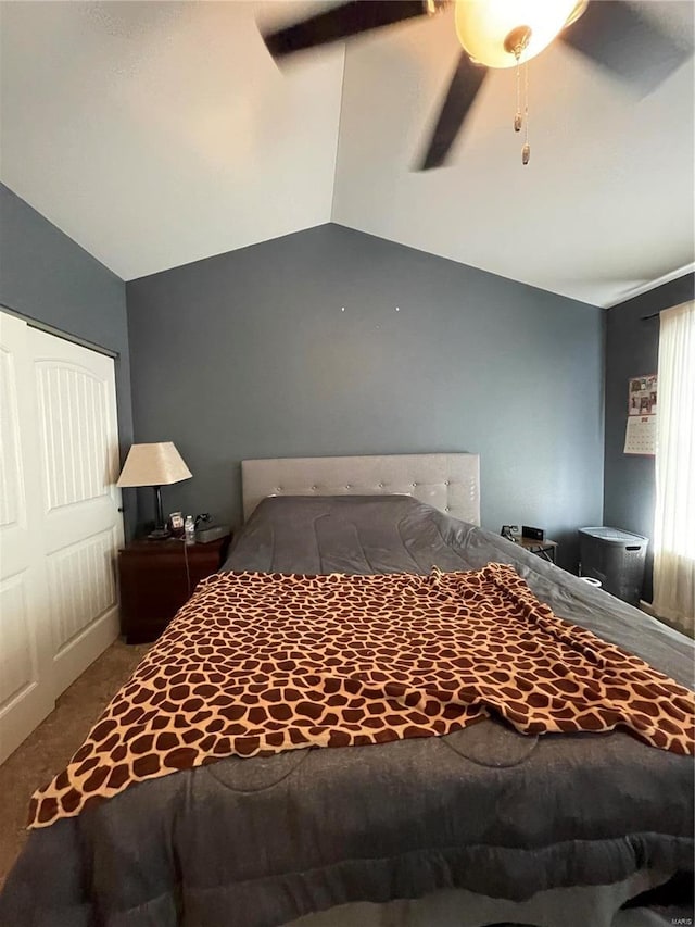 unfurnished bedroom with ceiling fan, carpet flooring, and vaulted ceiling