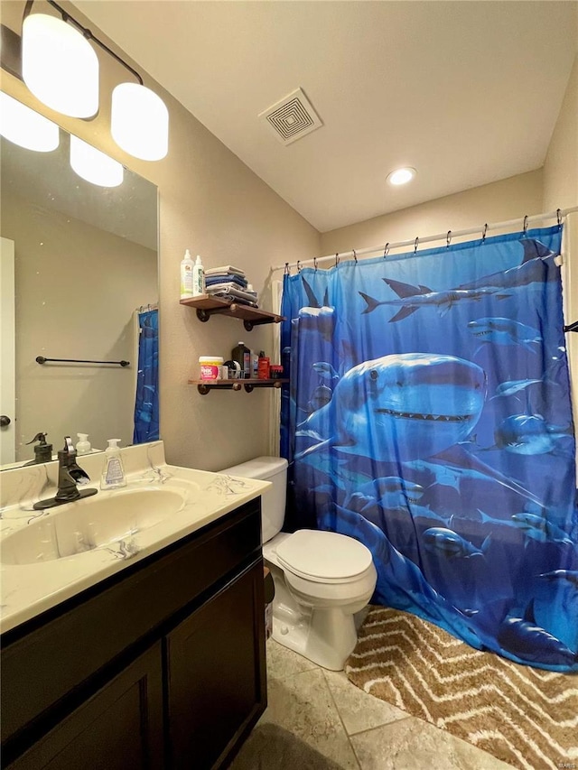 bathroom featuring walk in shower, vanity, and toilet