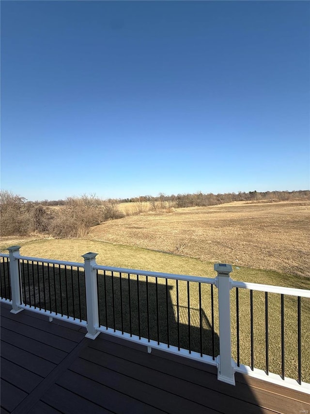 wooden terrace featuring a rural view