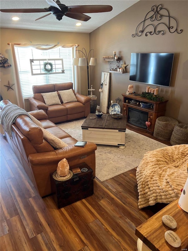 living room featuring hardwood / wood-style flooring and ceiling fan