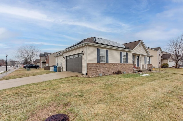 view of front of home with a garage, a front lawn, and solar panels