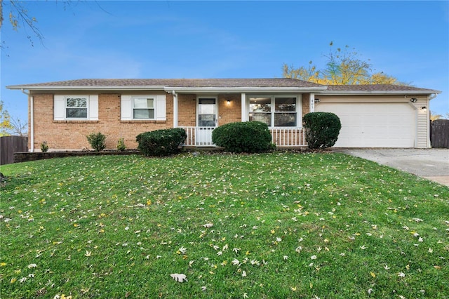 single story home with a porch, a garage, and a front lawn