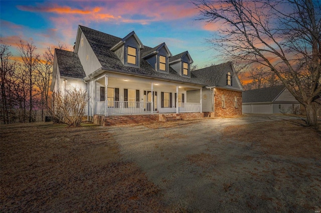 new england style home featuring covered porch