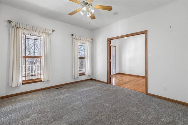 carpeted spare room with ceiling fan