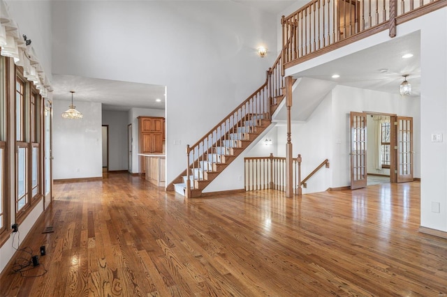 interior space featuring wood-type flooring and a high ceiling