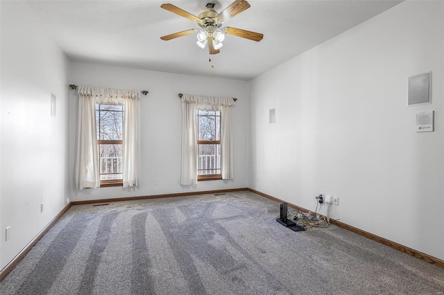 unfurnished room with ceiling fan and carpet