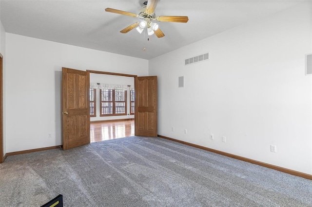 spare room featuring carpet and ceiling fan