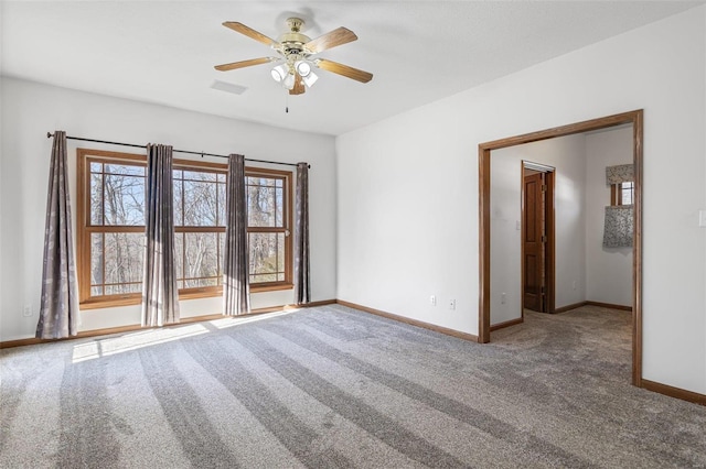 spare room featuring ceiling fan and carpet flooring