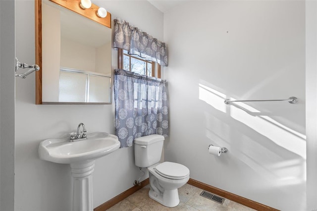 bathroom featuring tile patterned floors and toilet