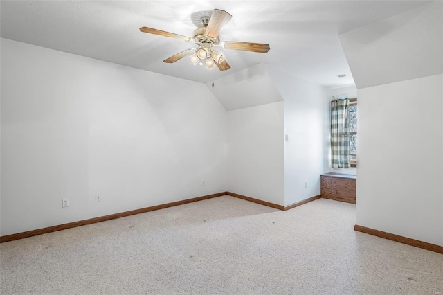 bonus room with ceiling fan, light colored carpet, and lofted ceiling