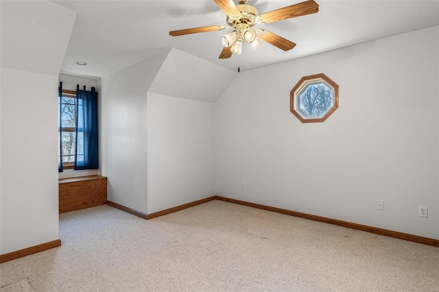 additional living space featuring light colored carpet, plenty of natural light, and lofted ceiling