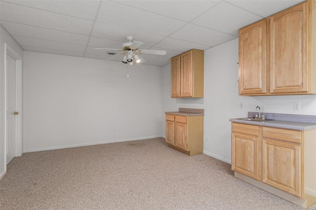 kitchen featuring light carpet, sink, light brown cabinetry, and ceiling fan