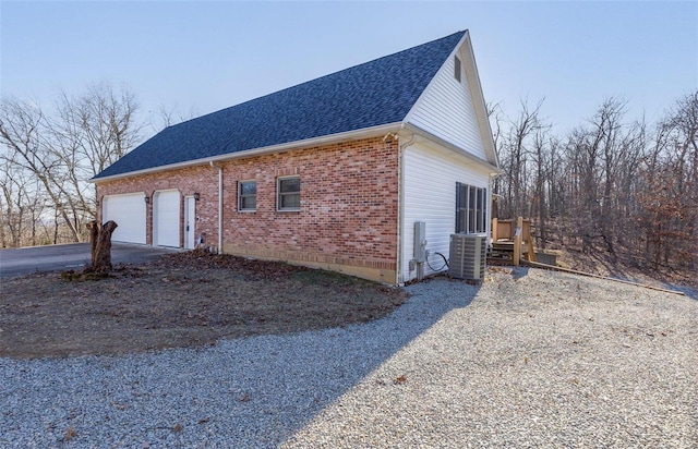 view of home's exterior featuring a garage and central AC unit