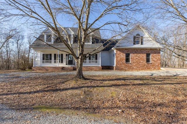 cape cod-style house with covered porch