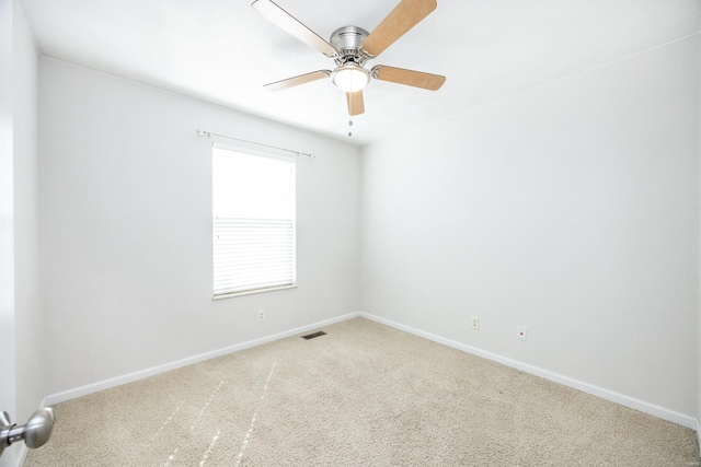 carpeted empty room with ceiling fan, visible vents, and baseboards