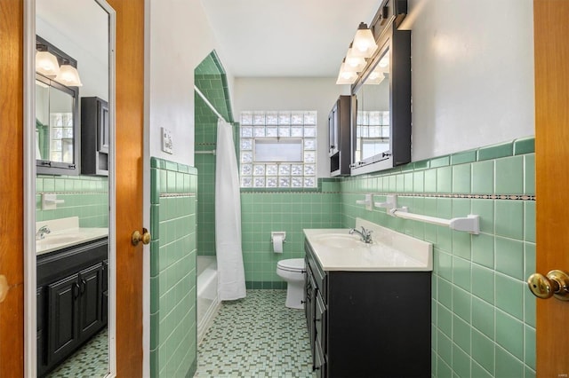 full bathroom featuring vanity, toilet, shower / tub combo, and tile walls