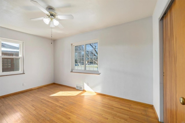 unfurnished bedroom with ceiling fan, light wood-type flooring, and a closet