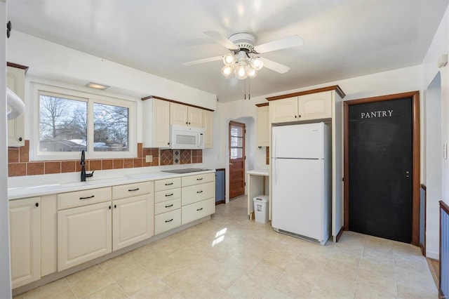 kitchen featuring backsplash, white appliances, sink, and ceiling fan