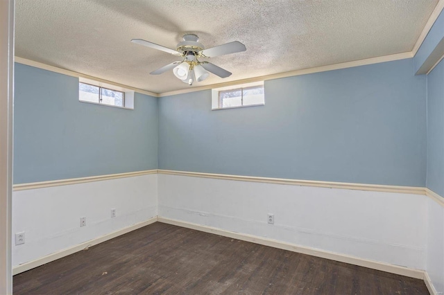 basement with crown molding, dark hardwood / wood-style flooring, and a textured ceiling