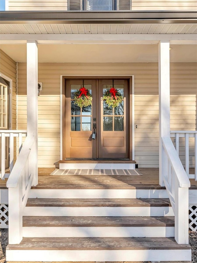 entrance to property with french doors and a porch