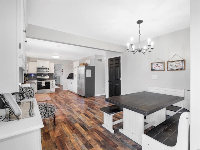 dining room with an inviting chandelier and dark hardwood / wood-style floors