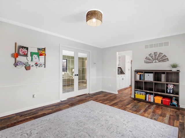 interior space featuring crown molding, dark wood-type flooring, and french doors