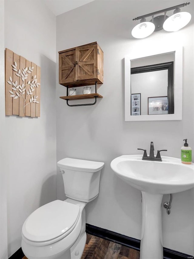 bathroom with wood-type flooring and toilet