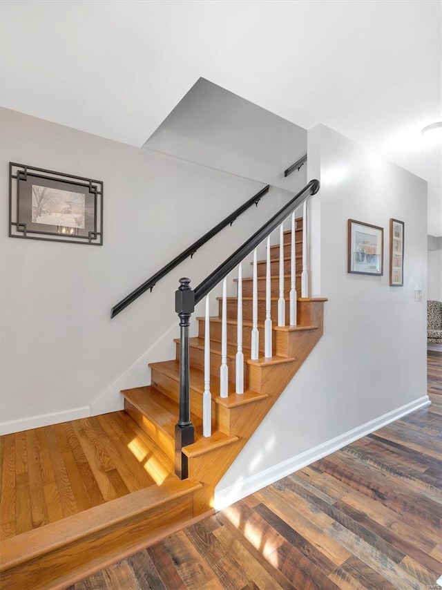 staircase featuring wood-type flooring