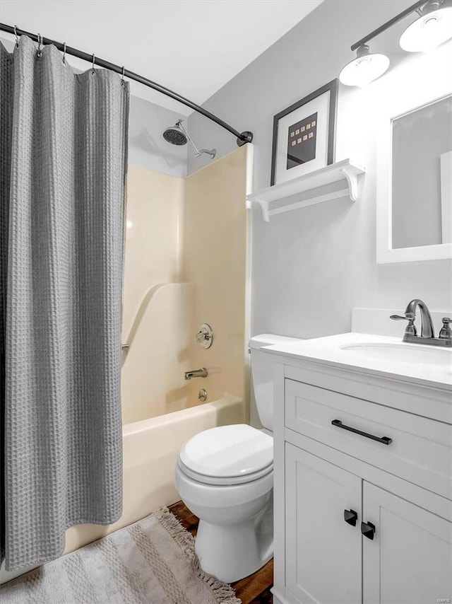 full bathroom featuring shower / bathtub combination with curtain, vanity, and toilet