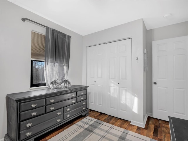 bedroom with a closet and dark hardwood / wood-style floors