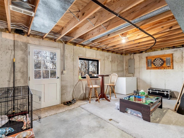 basement with electric panel and refrigerator